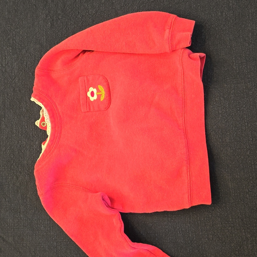 Mini Boden in pink sweatshirt with lace collar.